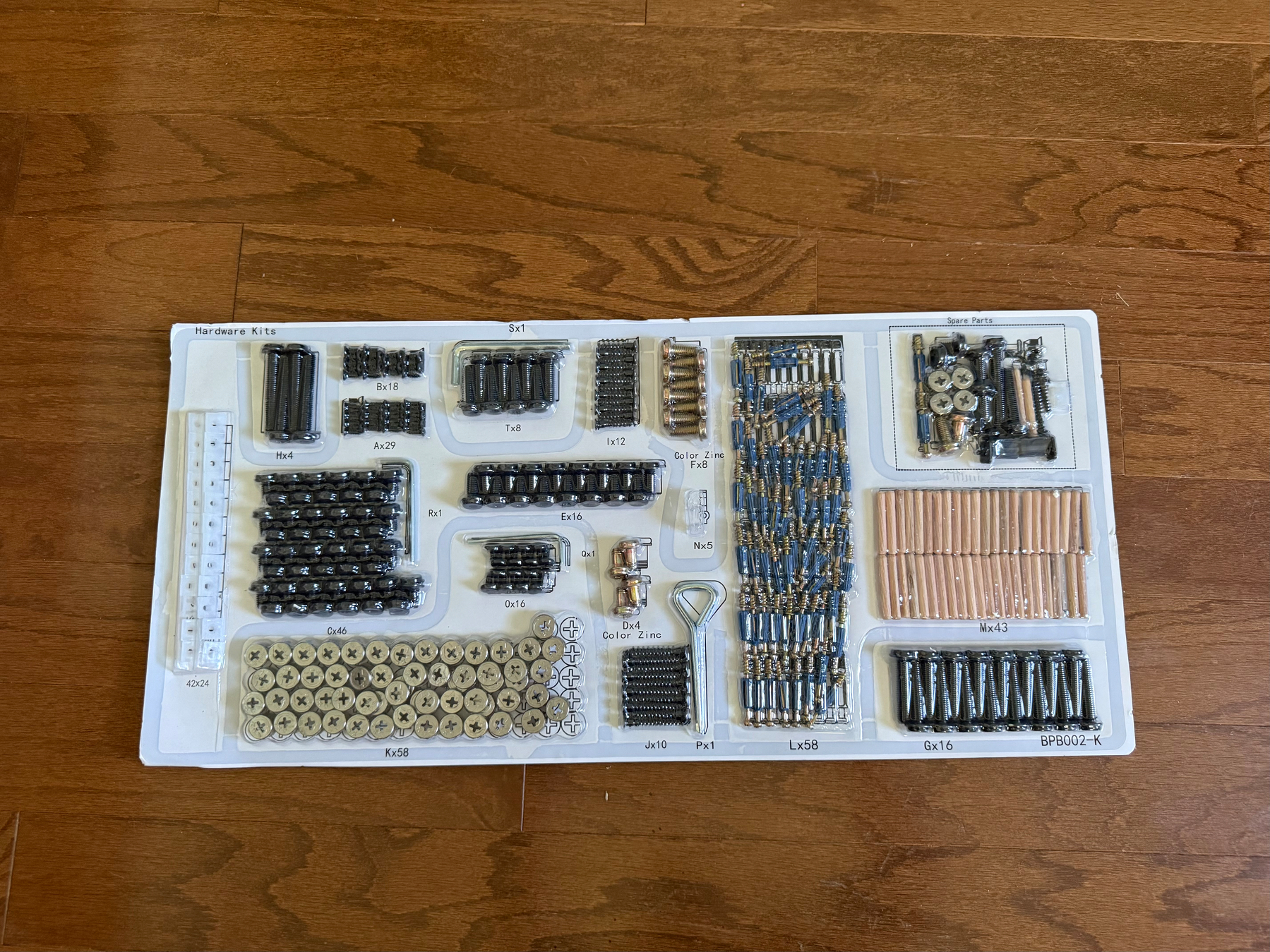 A 22 inch by 10 inch sheet of cardboard with 17 sections of parts to screw together  for a piece of furniture. 